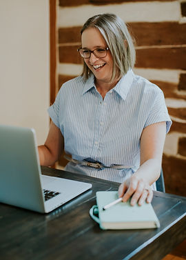 Professional portrait of Theresa Smith sitting at her desk, engaged in a virtual meeting.