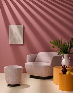 Dramatic shadows cast over a contemporary lounge chair create a graphic look of sun rays