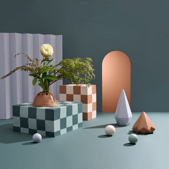 Painted geometric shapes and checkboard plinths create the effect of a re