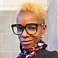 Woman with blonde hair and glasses looking at the camera. icreateart2.com