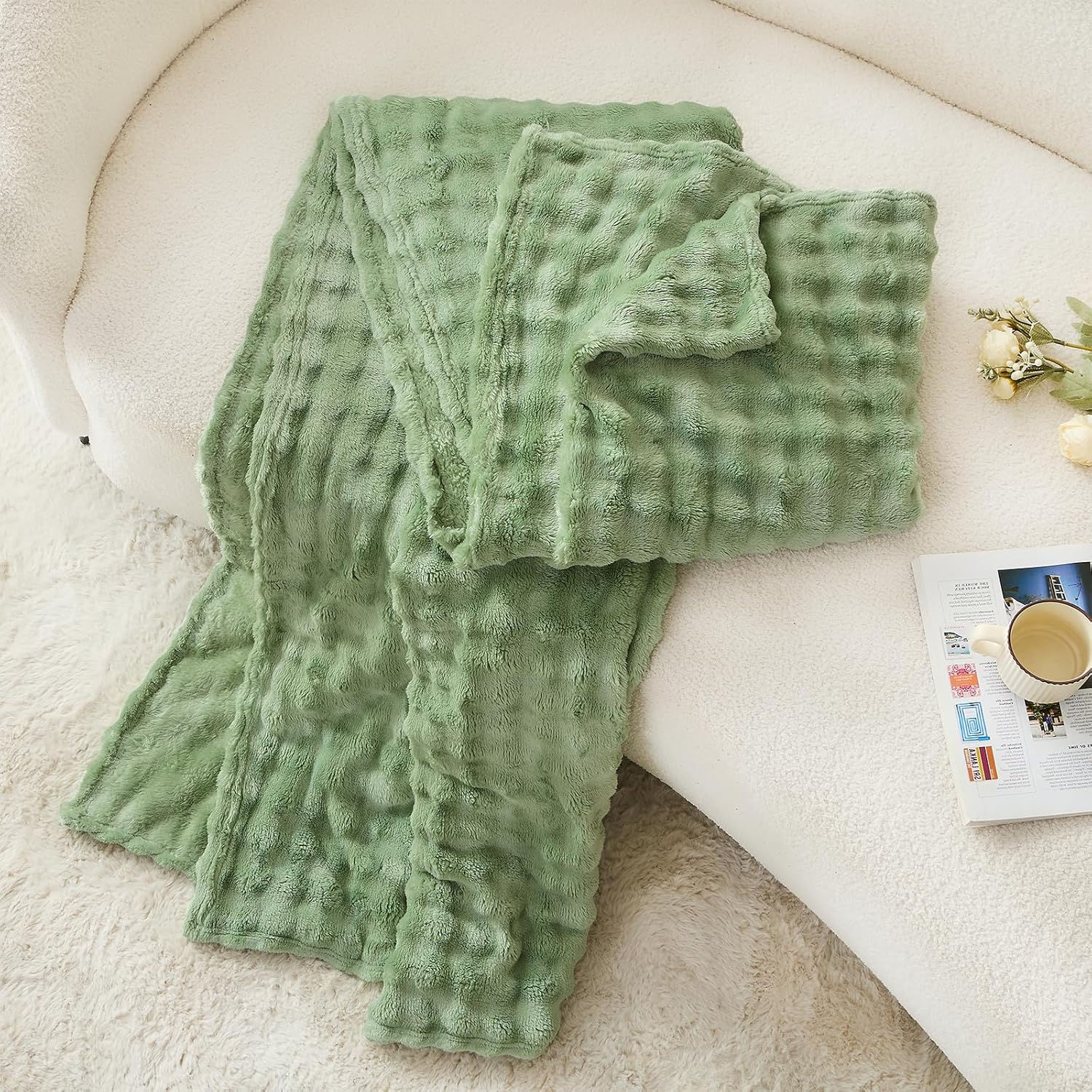 Sage green Artisan Bubble-Knit Heirloom Throw on a sofa.