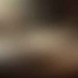 Open book with watercolor sketches, a pen, glasses, and steaming coffee on a wooden desk. Sunlight streams through a window, creating a calm vibe.