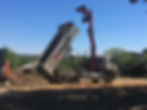 Grab lorry tipping recycled stone