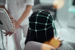 A woman with a neurofeedback therapy device mapping her brain