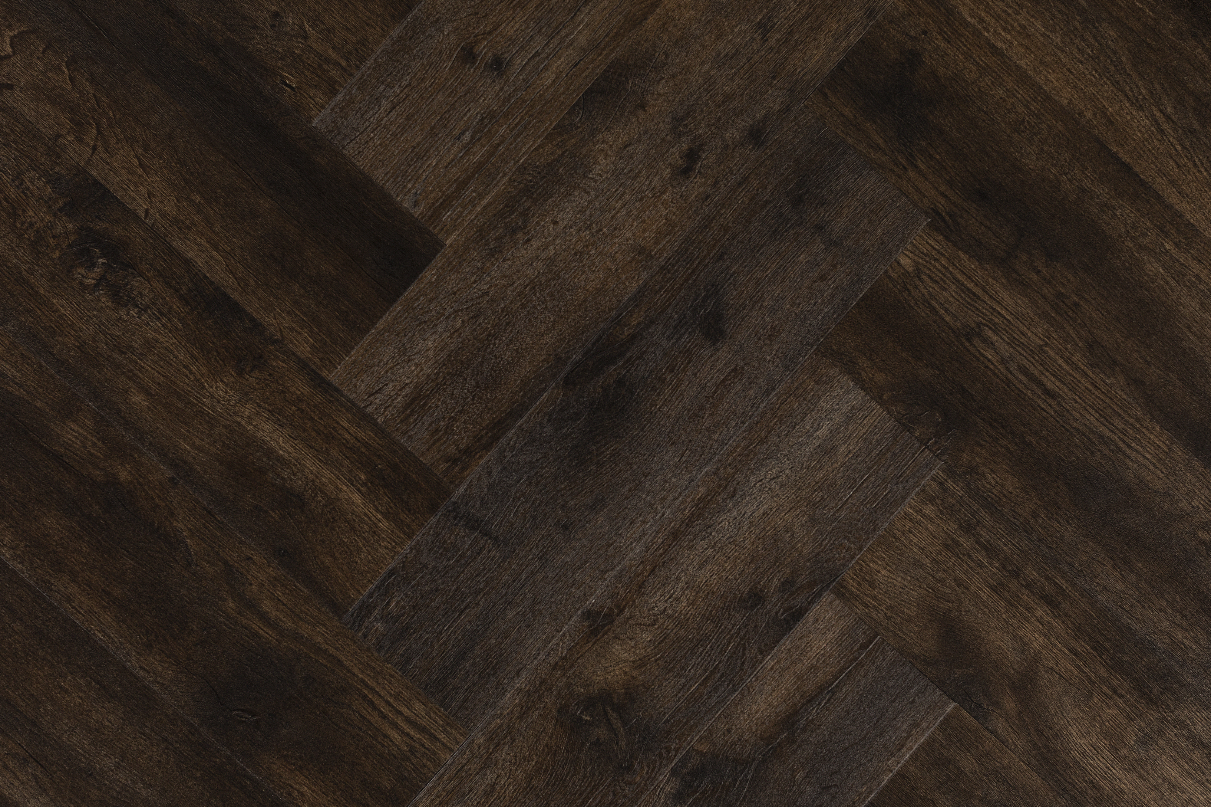 A very dark, rich wood effect floor in a herringbone pattern