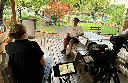 non-profit video production outdoor interview with camera setup and interviewer recording subject