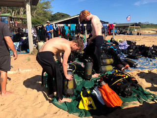 Diving interns kitting up dive gear before a scuba dive in south africa