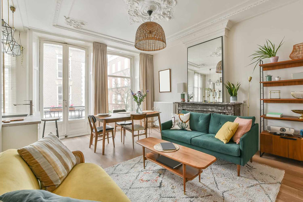 Cozy and elegant living room featuring a mix of vintage and modern elements, with a green velvet sofa, stylish wooden furniture, and abundant natural light from large windows.