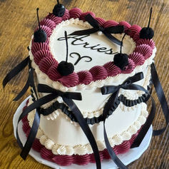 Heart-shaped Aries birthday cake with black bows and cherries. Fort Lauderdale FL