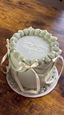 White cake with decorations on a wooden table, custom cakes order