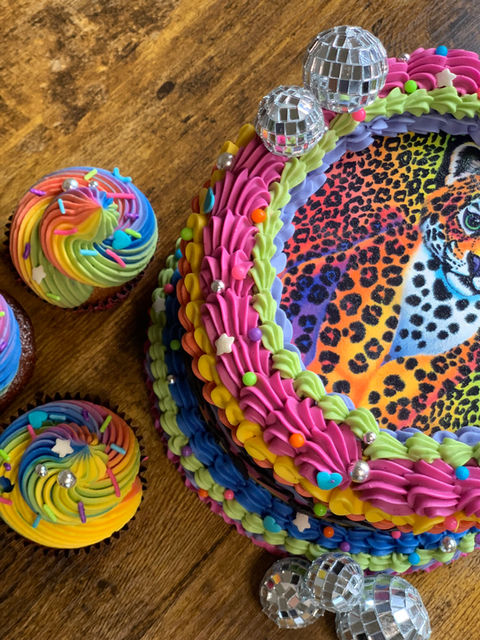 Neon rainbow cake with animal print design and colorful buttercream piping
