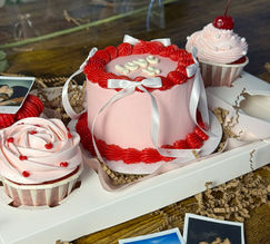 Pink cakes and cupcakes, Valentine's special, with photos on wooden table, Davie FL.