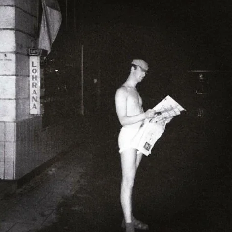 john-holding-a-daily-express-at-the-back-of-bambi-kino-in-v0-dqi547v7ys5a1.webp