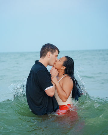 Couple kissing in shallow ocean water