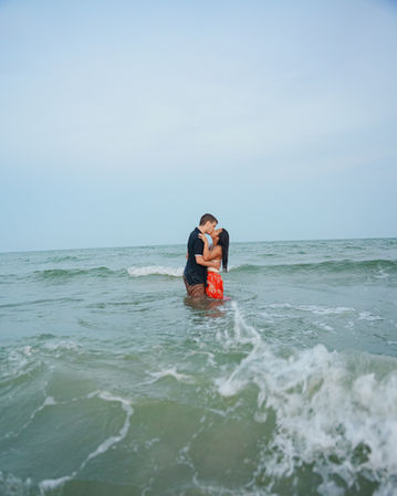 Couple standing in ocean water together