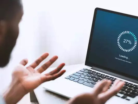 Frustrated man waiting for a slow laptop to load
