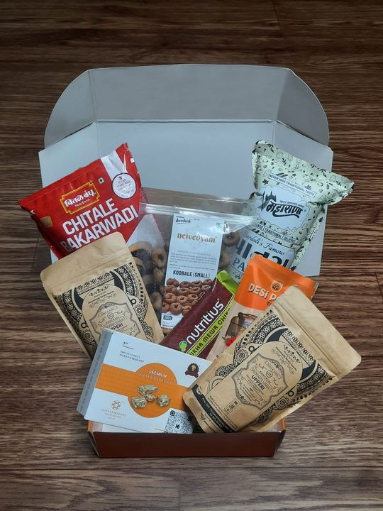 Kaamik's gift box with 8 unique and delicious Indian snacks sourced directly from century old food artisans along with an exploration guide that contains a short descrption about the items and a personalized thank you note