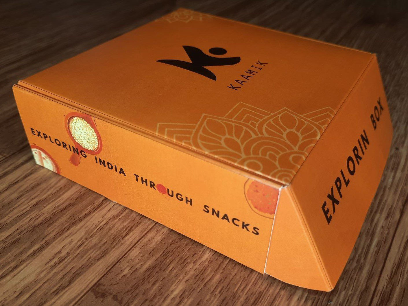 Kaamik's upgraded exlporin snack box with bigger size, colorful outlines and tons of new design. Left side view of the premium Indian snack box/giftbox