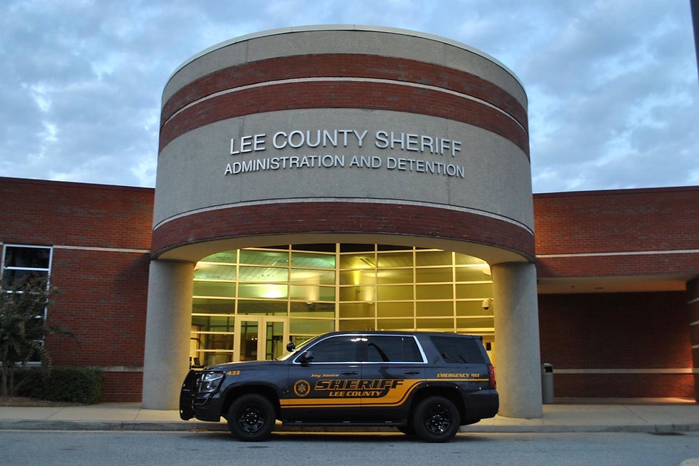 Eye-level view of Alabama sheriff's office building with American flag