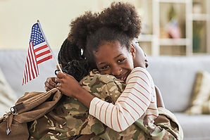 VETERAN HUGGING CHILD.jpg