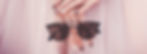 Sunglasses in woman's hand