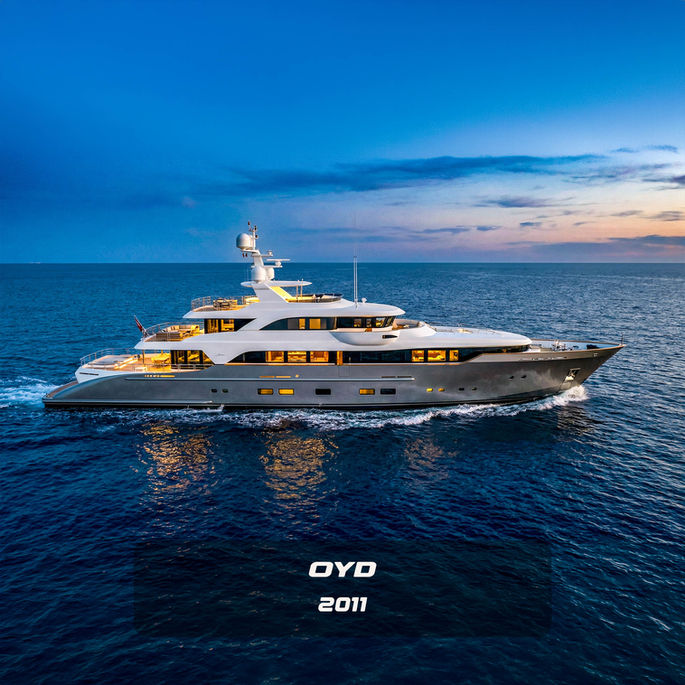 Side profile of a classic 60-meter OYD superyacht at twilight, featuring a timeless grey hull and white superstructure, designed by Yacht exterior designer Emrah Onemli.