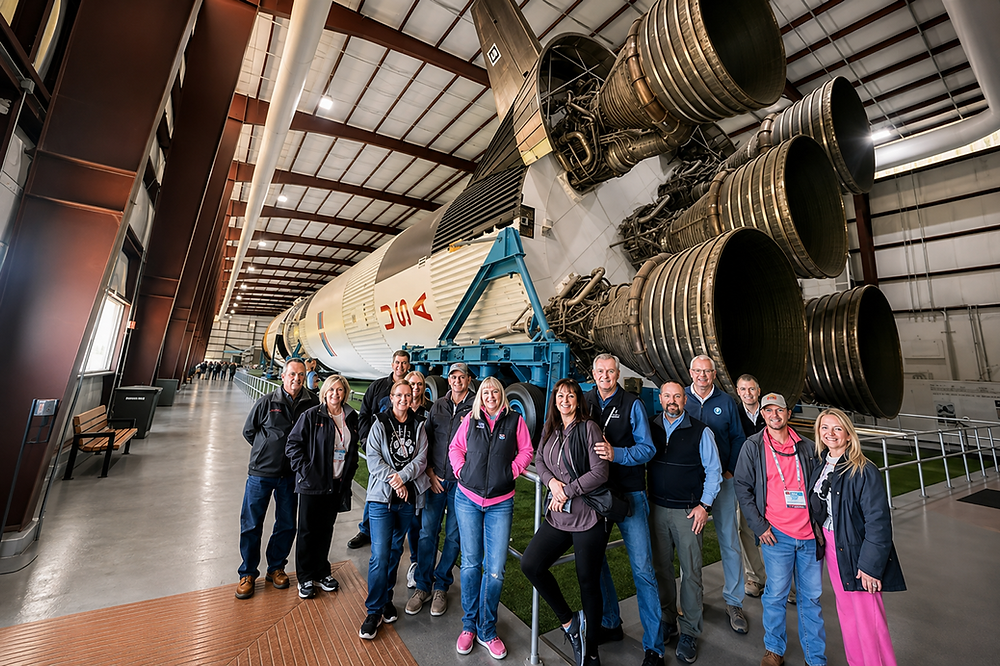 Guests enjoy a Texas-style photo in front of Independence Plaza as part of our NASA Ticket and Round-Trip Transportation combo package.
