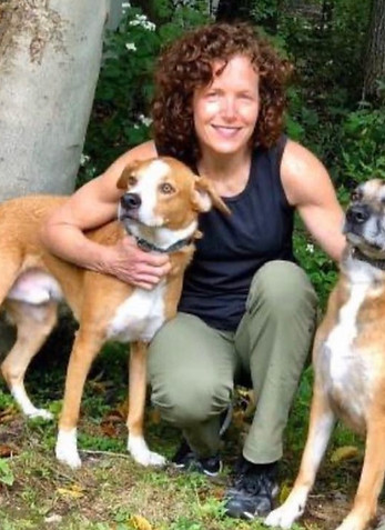 Jill the pet sitter with two brown and white dogs