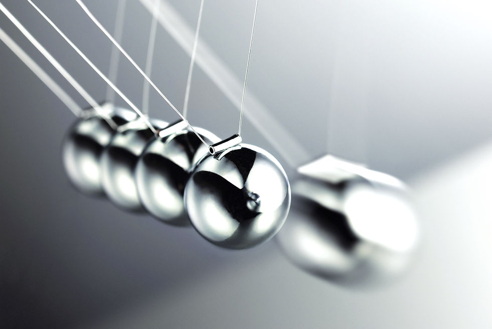 Newton’s cradle illustrating how momentum and complexity can create downstream effects.