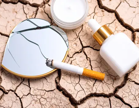 Close-up of a cigarette burning into cracked, dry skin — symbolic, metaphorical shot