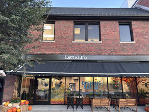 Latte Life’s red-brick storefront at 318 Armour Road in North Kansas City, with a black awning and autumn pumpkins. Photograph by LaRee Durden.