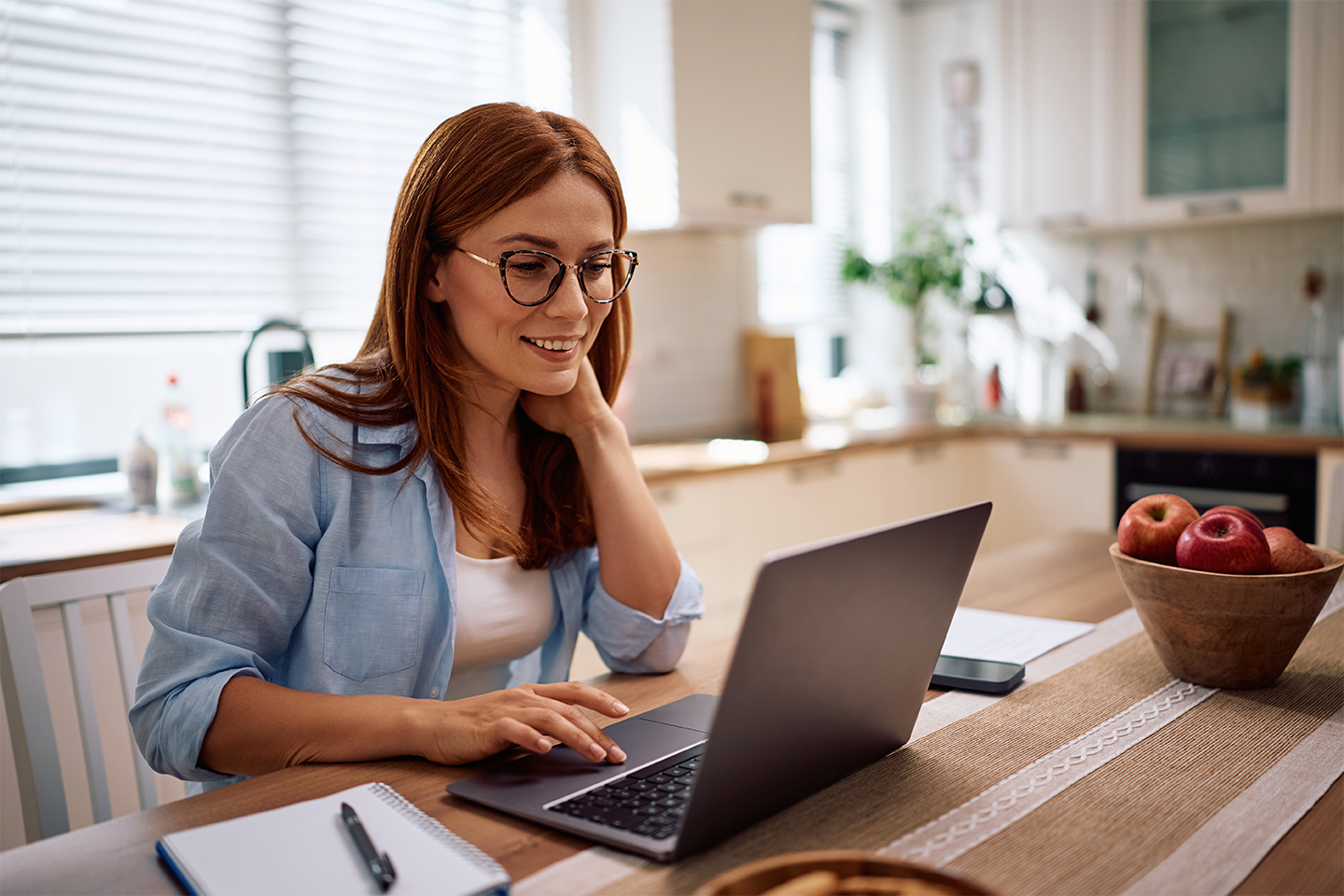 woman-working-on-laptop-in-a-bright-kitchen-2026-01-09-11-53-14-utc_v2.webp