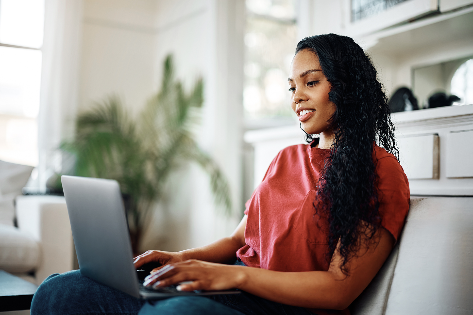 A woman reading mental health resources on her laptop at home exploring practical guides from Guided Therapy Co.