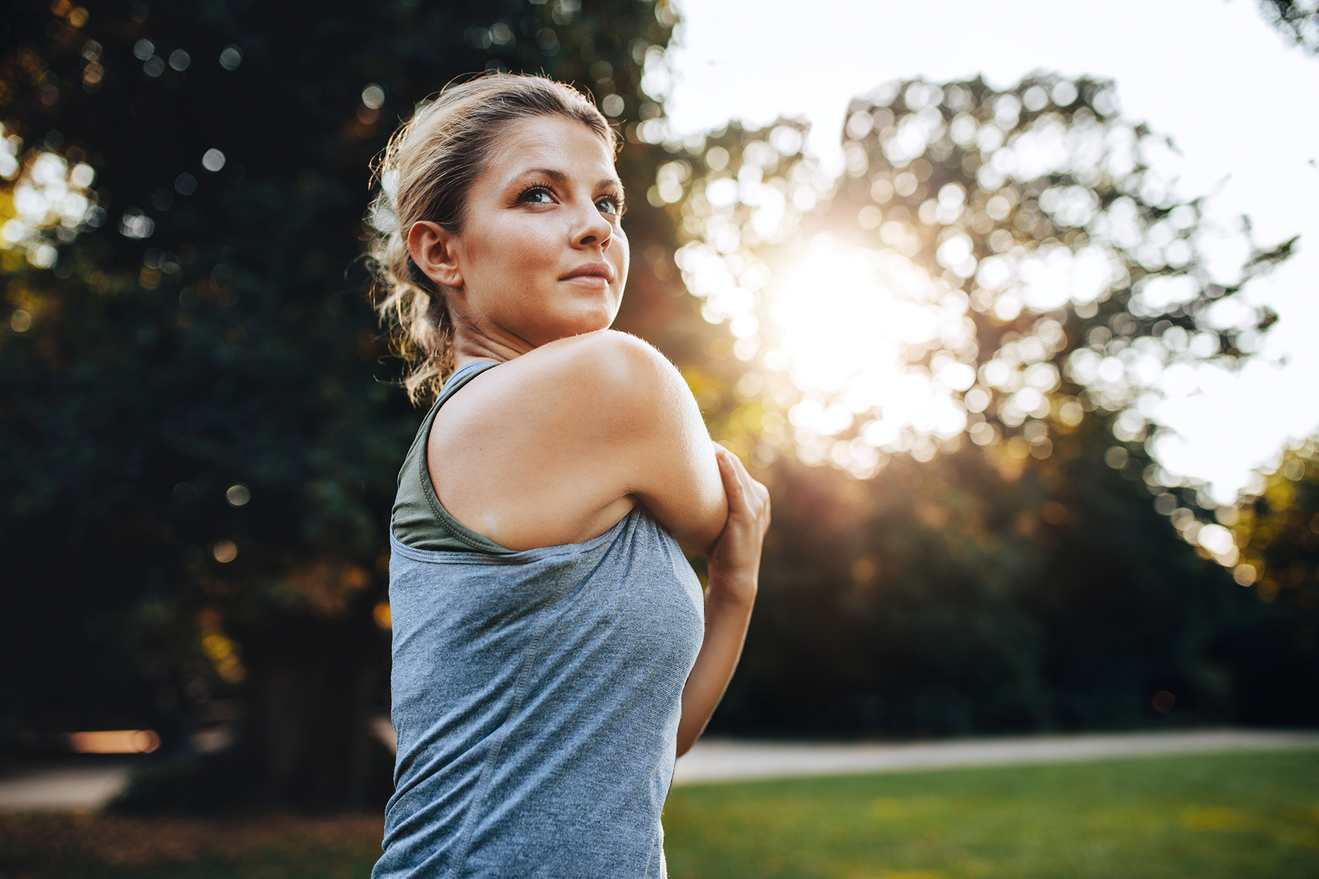 Young woman exercising in a park excited to be practicing a new skill learned in her therapy sessions