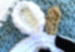 A close up of a crocheted cow ear and horn made with I Love This Yarn.