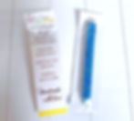 A pen covered in rhinestones in a cellophane bag and another cellophane bag with a Pen Care Instruction Card sitting next to it.