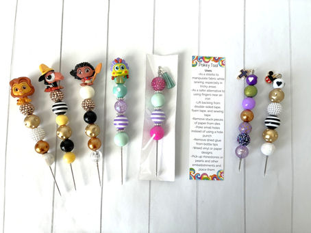 Colorful beaded handmade Pokey Tools with cartoon tops on a striped surface; text outlining craft tool uses nearby. Bright and playful design.