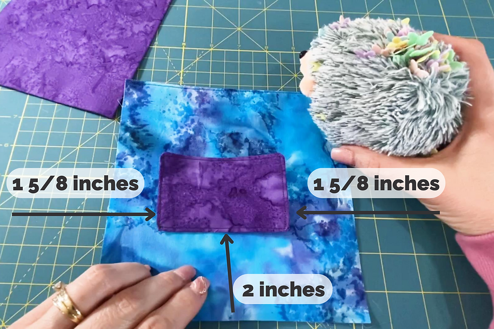 A piece of fabric and measurements showing where to pin a pocket to the front.