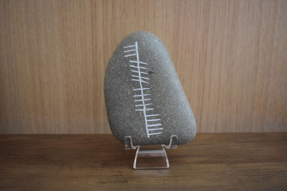 Neart (Strength) Ogham script carved on a gray stone