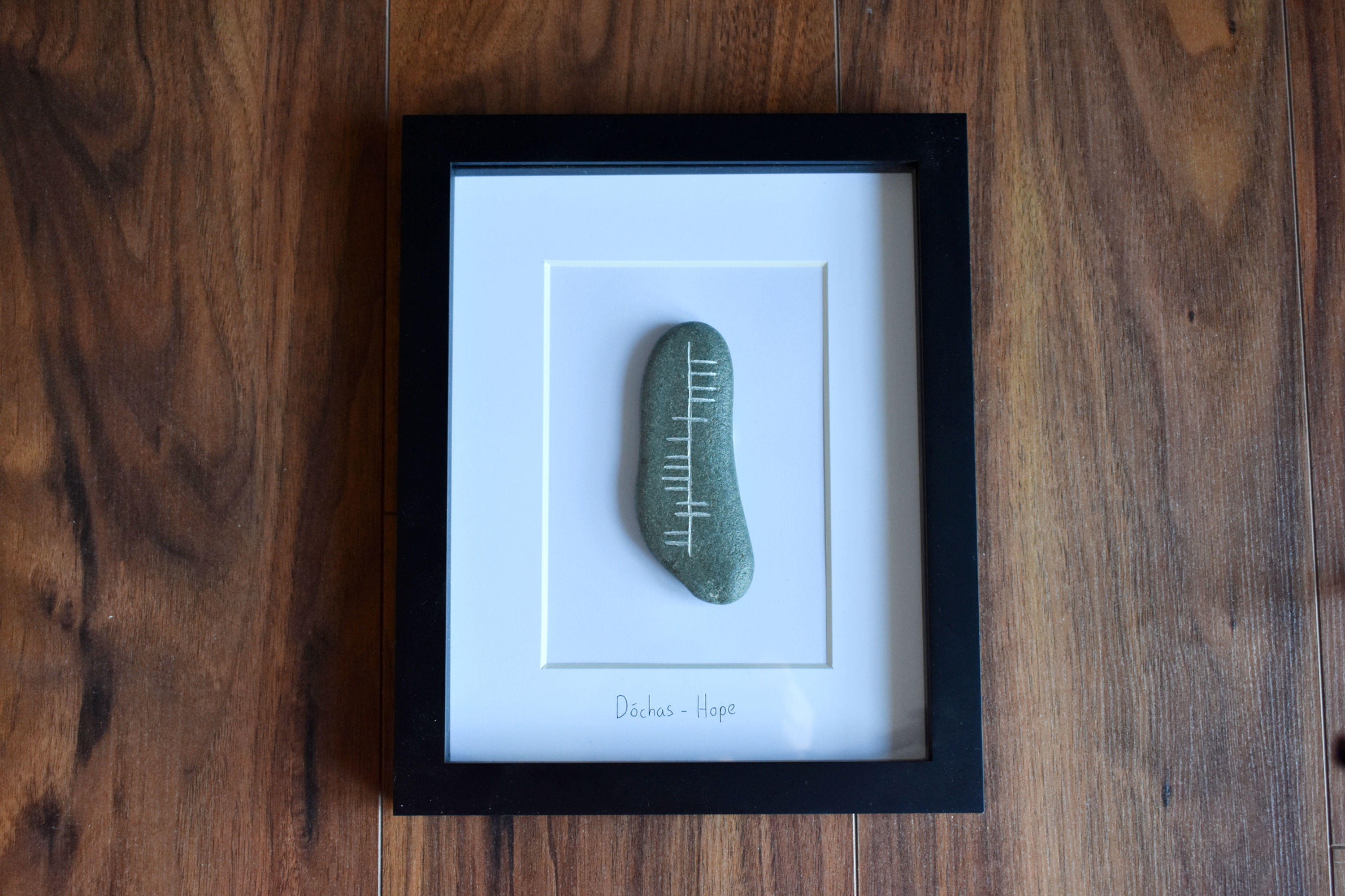 Dóchas (Hope) Ogham Stone in a black frame
