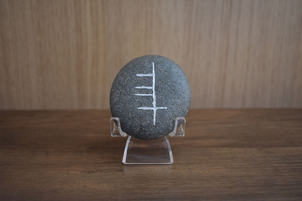 Round stone with Ogham inscription for Ádh or luck