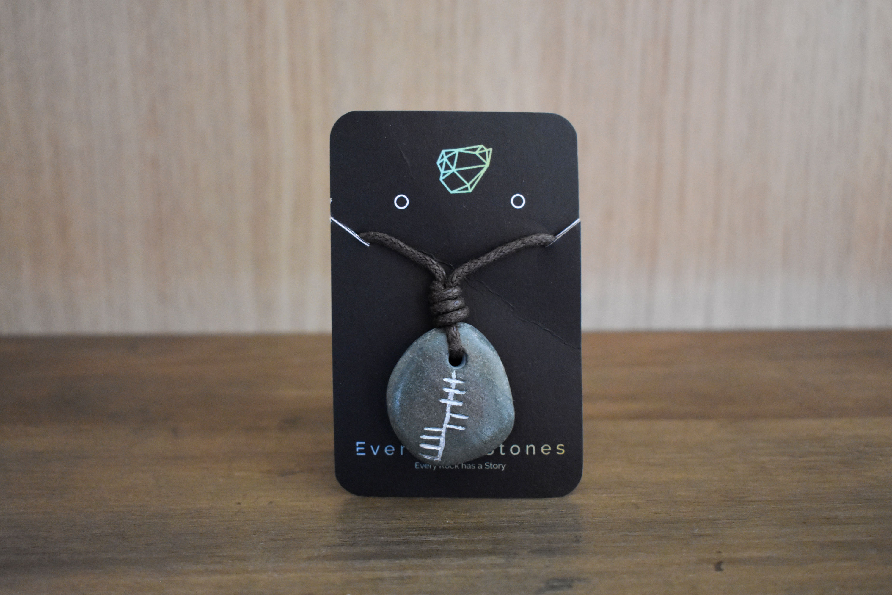 Clú (Honour) Pendant with Ogham inscription on grey stone.