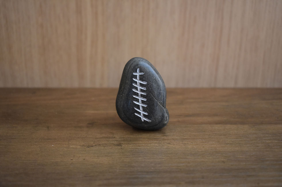 Ogham stone symbolizing Grá (Love) on a wooden surface