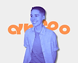 Smiling person with short hair in front of an orange logo