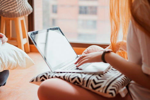 A teen on her laptop searching for therapy services near them for support with anxiety, stress, and social issues.
