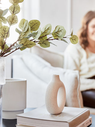 Taylor Geim on a couch ready to provide in-person and online Psychotherapy Services