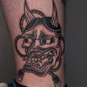 traditional hannya mask tattoo london bold linework american traditional tattoo black shading mask