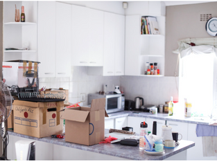 packing up belongings as moving home, boxes in the kitchen