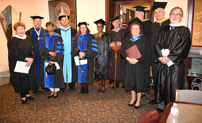 Campus faculty dressed in graduation regalia