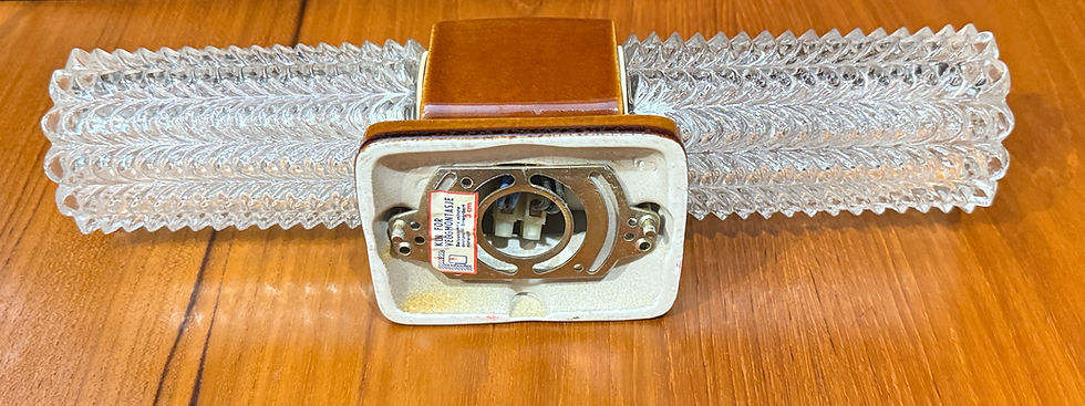 Miniatyrbilde: Vintage vegglampe med brunt keramikk og bølgeformede glasskjermer på treoverflate.